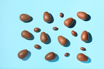 Delicious chocolate eggs on blue background