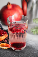 Glass of tasty pomegranate cocktail on table