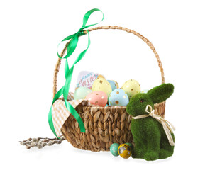 Basket with painted Easter eggs, bunny and willow branches on white background