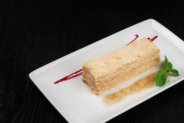 Esterhazy traditional cake with mint on black wooden background