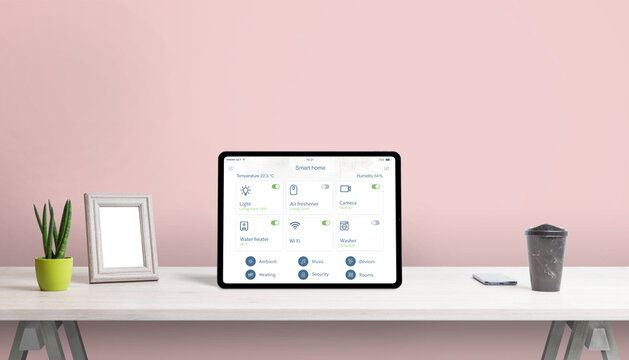 Tablet with smart home app on home desk. Concept home automatization app with important home devices control