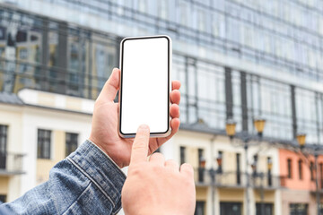 Close-up, finger fart Mockup of a smartphone in the hands of a man. Against the backdrop of a glass business center.