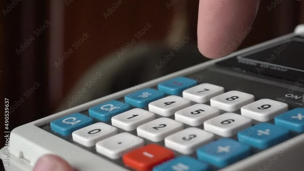 Aufkleber typing on calculator from the 70's in macro view