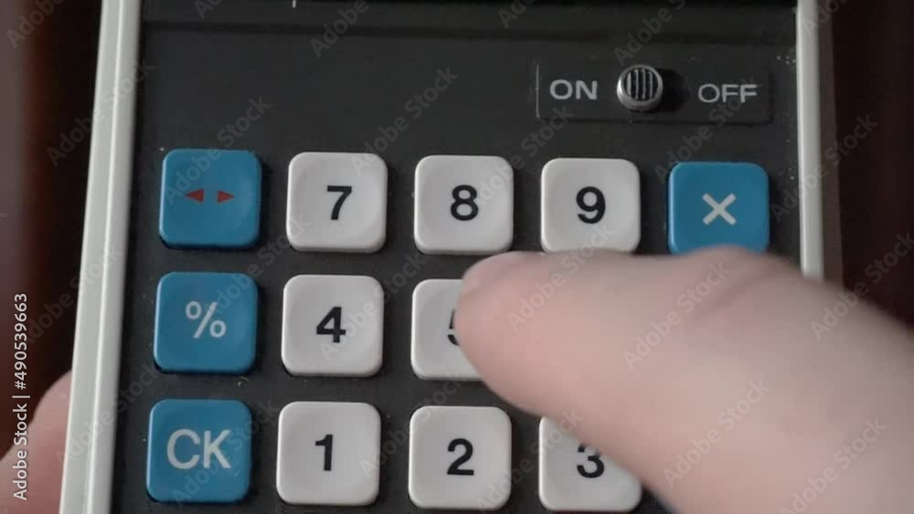 Aufkleber typing on calculator from the 70's in macro view