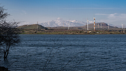 View of the Golan Hills and the snow covered  Hermon Mountain Rnge in the background  as seen from the  water reservoir at the foot of Mount Bental, Golan Heights, Israel.