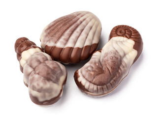 Chocolate sweets shaped as seashells isolated on white background