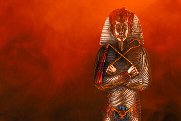 egyptian golden pharaoh statue in red smoke - obrazy, fototapety, plakaty