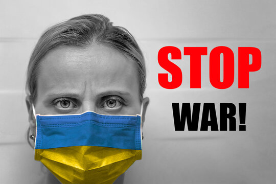 Face woman in mask with Ukraine flag looks at the camera. Text stop war