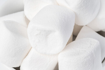 Background of marshmallow pieces on white close up