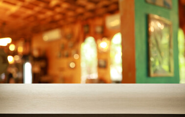 Empty wooden table in front of abstract blurred background of coffee shop . can be used for display or montage your products.Mock up for display of product