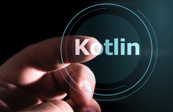 Hand pressing Kotlin button on virtual screen. Kotlin programming language.
