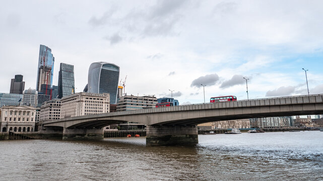 London Bridge and the River Thames, London. A view over the towards the skyscrapers of the financial City of London district.