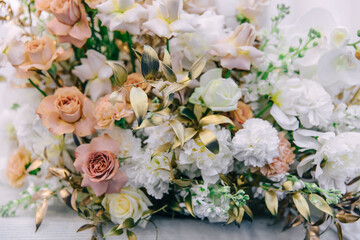 bouquet of orchids, roses and peonies on the table for newlyweds