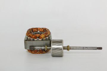 Copper coil old electric fan motor and spindle on a white background