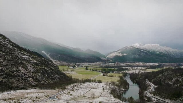 Aerial view of Ardal, Norway. Valley with river and snowy mountain in background