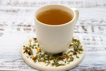 Relax herbal tea on a wooden background. Herbal tea prepared with lemon balm leaves, jasmine...