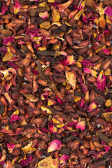 Pomegranate tea. Close-up herbal tea. Herbal tea prepared with pomegranate seeds, pomegranate peel, hibiscus, clove, cinnamon particles.