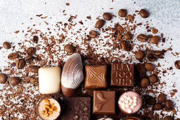 Chocolate candies and chocolate pieces pile for background