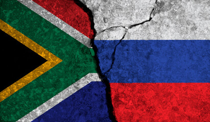Political relationship between South Africa and russia. National flags on cracked concrete background