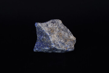 Raw specimen of blue Lapis Lazuli stone isolated on black background. Protective stone.