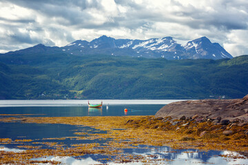 Norway. Landscape with fjord, boat and mountains on a summer day