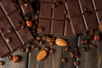 Roasted coffee beans with black chocolate close up