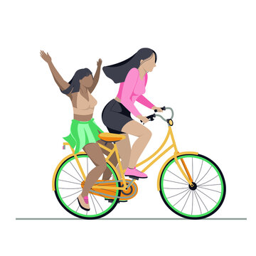 Joyful young women riding a bicycle together. Best friends or lovers having fun on a bike