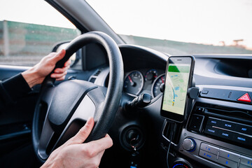 Gps device map system. Global positioning system on smartphone screen in auto car on travel road....