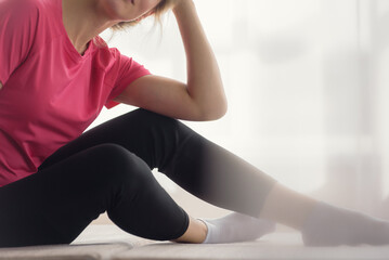 Closeup photo of young fit woman in sportswear exercising at home