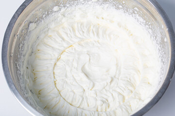 white whipped cream in metal bowl