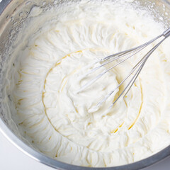 white whipped cream in metal bowl
