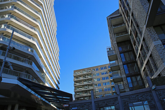 Nijmegen (Waalhaven), Netherlands - February 27. 2022: View on modern architcture buildings in dutch river harbor against blue sky