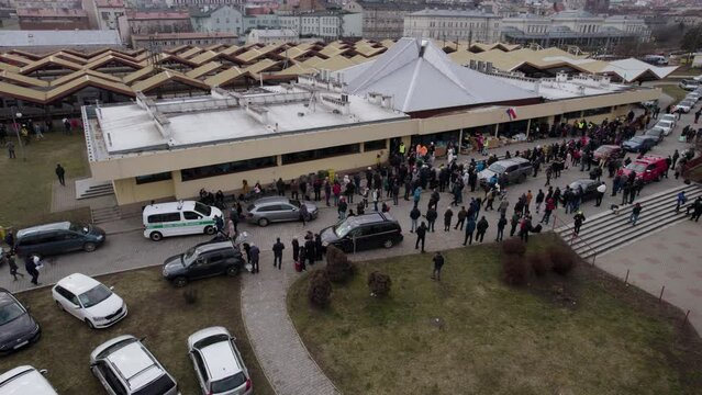 Aerial shot of the people waiting for war refugees next to the Przemysl train station - an escape from Lviv