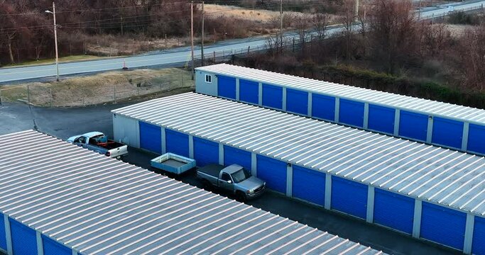 Pickup truck vehicles at self storage unit. Trailer to load and store personal belongings. Rental unit.