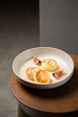 Cottage cheese pancakes with caramel cream sauce and fresh figs ( syrniki )