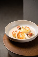 Cottage cheese pancakes with caramel cream sauce and fresh figs ( syrniki )