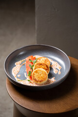 Cottage cheese pancakes, cream sauce with caviar, salmon and greens (  syrniki )
