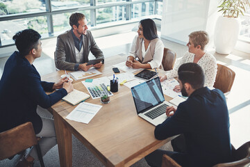 Planning ways to get success within their grasp. Shot of a diverse group of businesspeople having a...