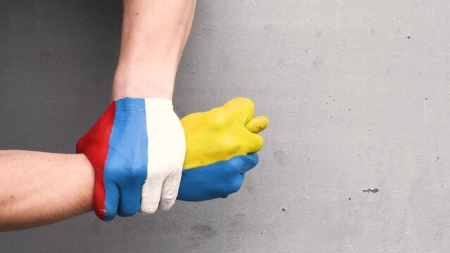 War in Ukraine with Russia, hands with colors of Ukrainian and Russian flags , gest of Ukrainian confruntare. Stop war in Ukraine video