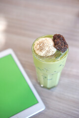 iced tea with mint on glass in coffee shop. Green tea with ice cream on top 