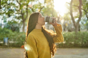 Woman drinking coffee in park