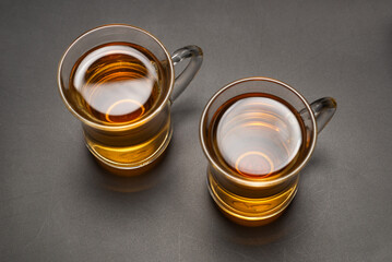 A turkish glass of tea on black background.