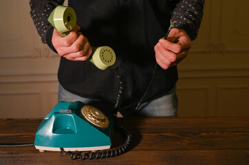 an old wired phone with a broken wire.