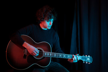 Guy plays classical guitar theater