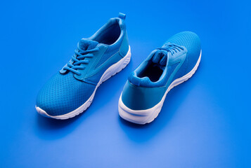 sporty blue sneakers. shoes on blue background. shoe store. shopping concept