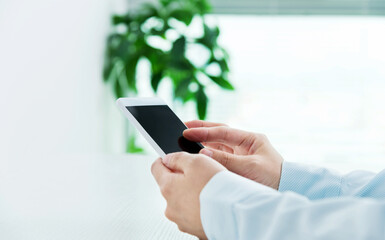 Close up of businesswoman hand using mobile phone