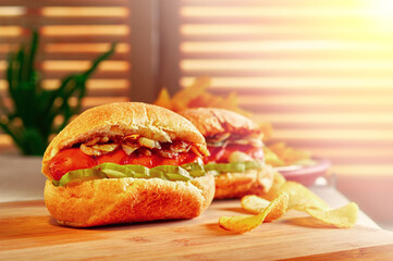 Hot dogs on wooden board in sunny cafe