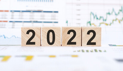 2022 letter on wood block cubes on white background with calendar and diagrams