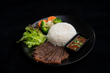 main dish food with grilled beef and rice, serve with vegetable and spicy sauce, meal meat on delicious dish for lunch, breakfast or dinner in Asian style fusion food