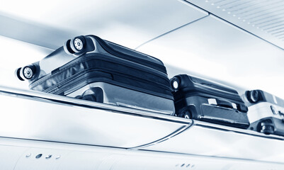 Luggage on shelf in modern train interior
